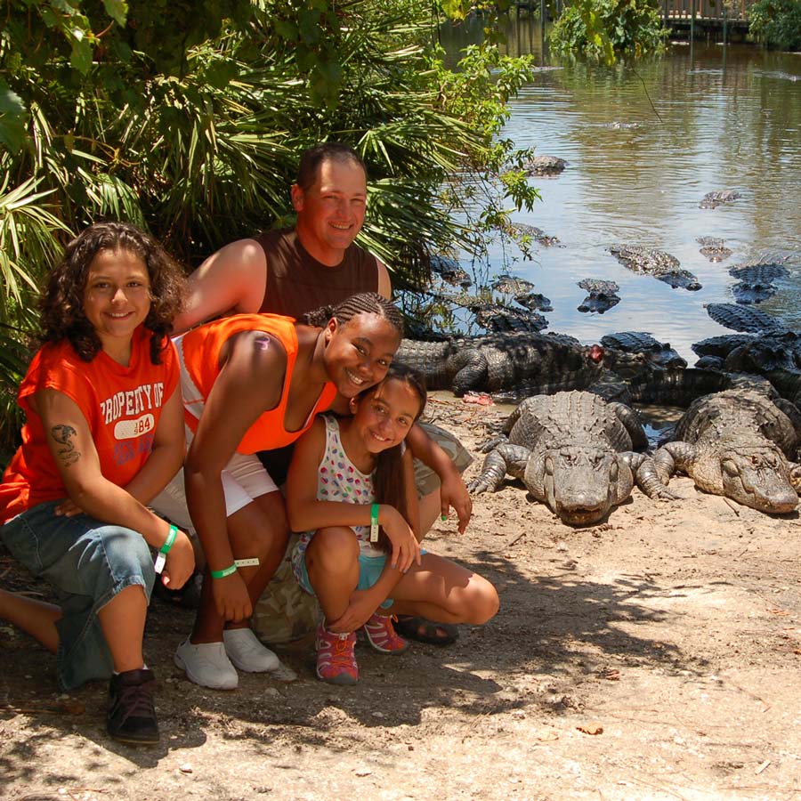 A family posing with an "i survived gatorland" picture
