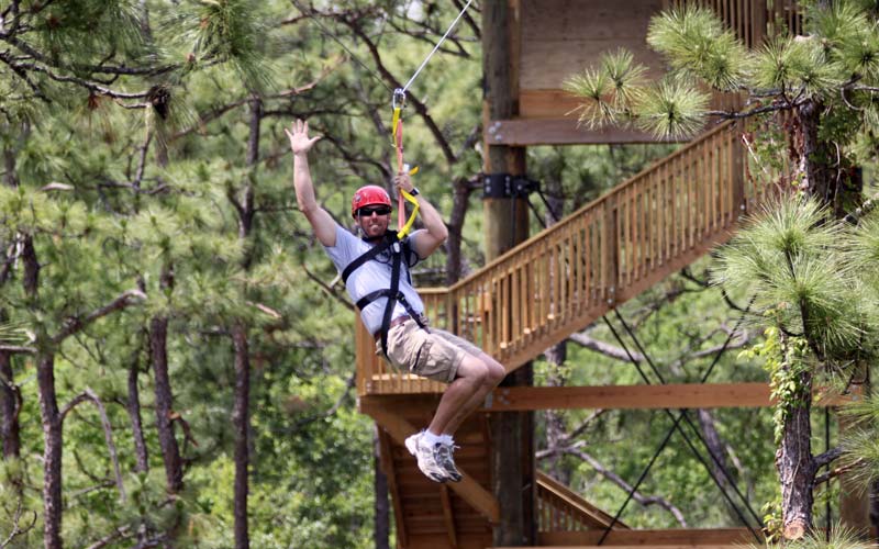 Man ziplines at Gatorland